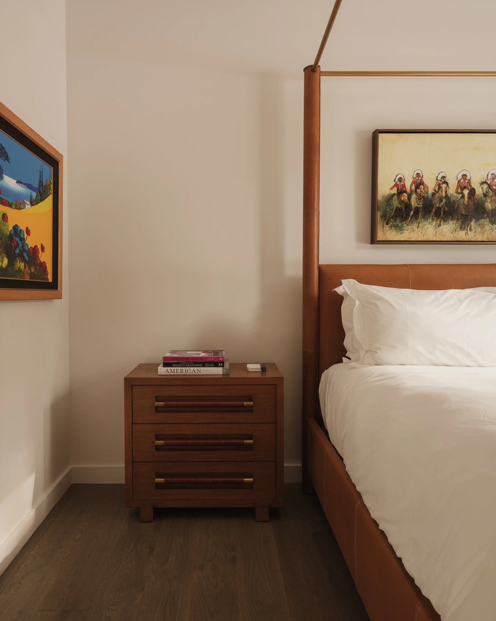 Bedside table detail beneath a leather canopy bed — interior design photography Big Sky Montana, Speedwell Cabin